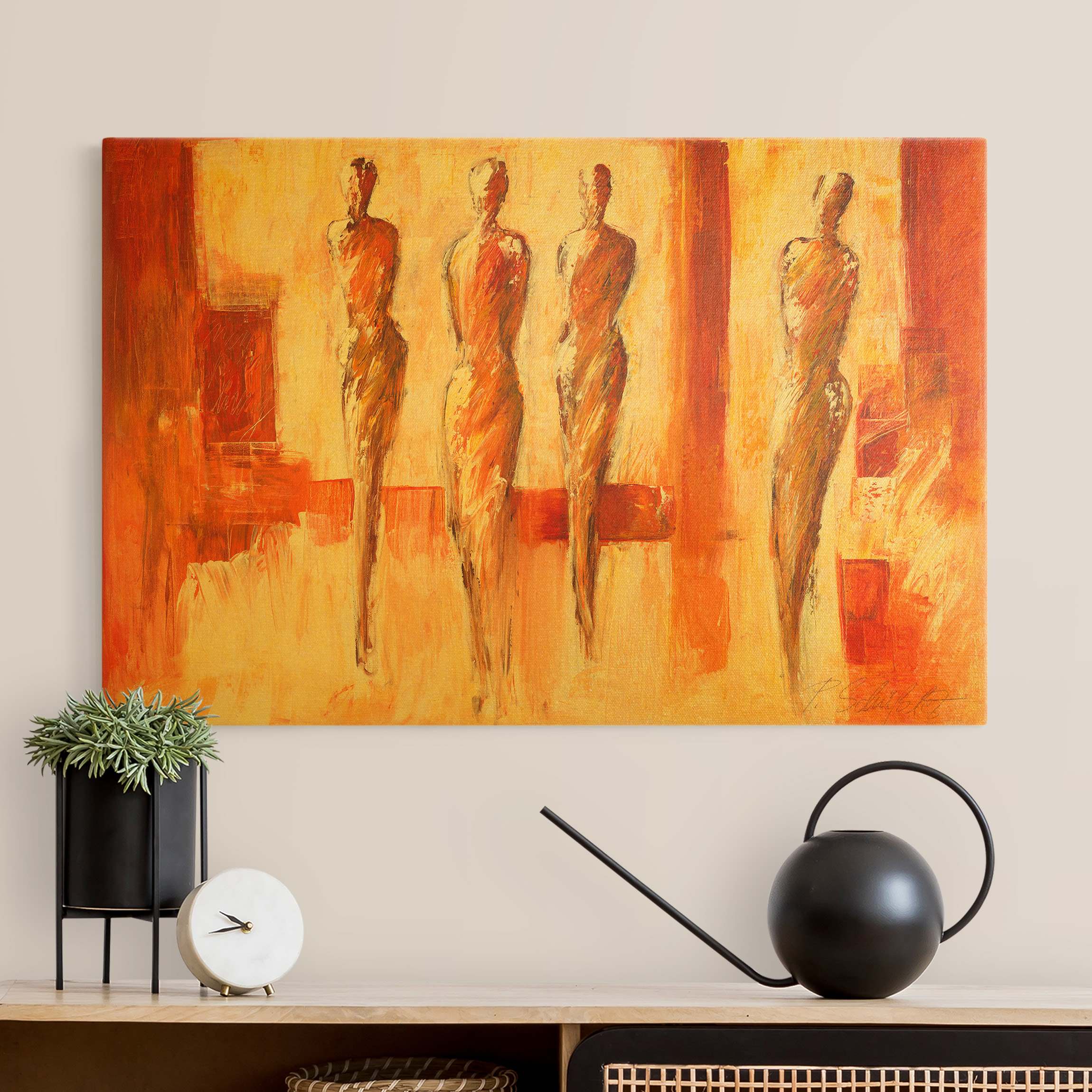 Leinwandbild Vier Figuren in Orange