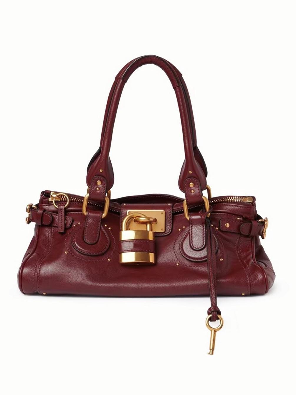 2026 Neue Herbst/Winter Vintage Vielseitige Schlosskopf-Tasche mit Nieten-Kissen-Tasche bordeaux