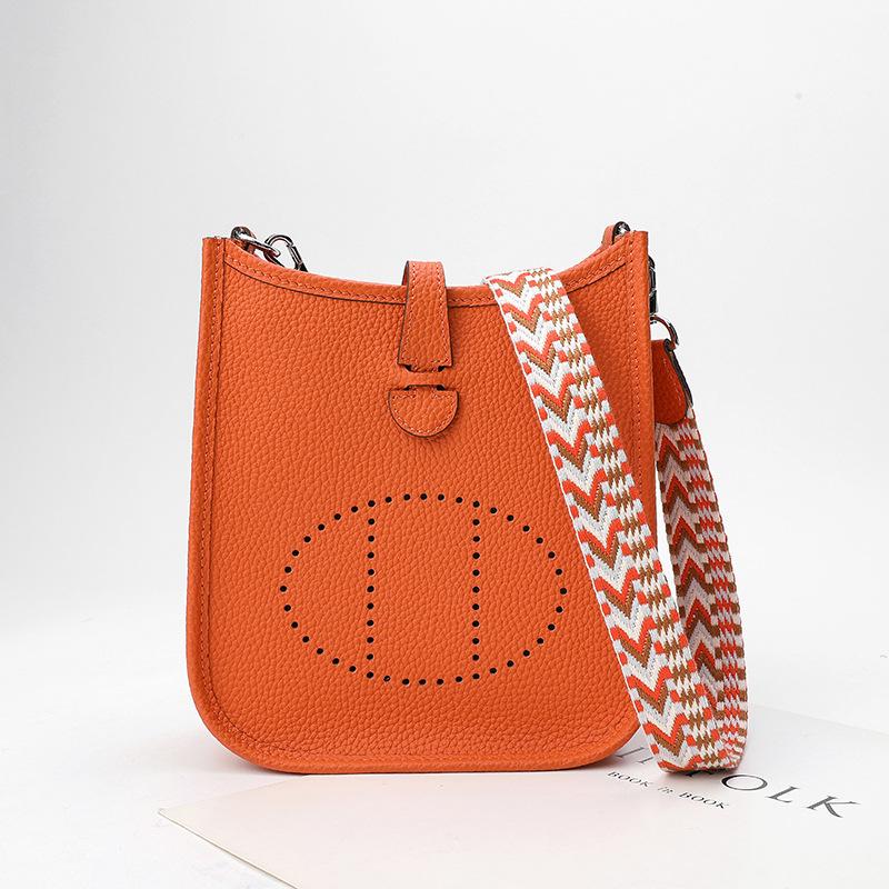 Fabrikgroßhandel erste Schicht Rindsleder Eimer Tasche Damen Tasche Litschi Muster Hohl Einzel Schulter Crossbody Tasche Hohl Design 17x6x18cm orange