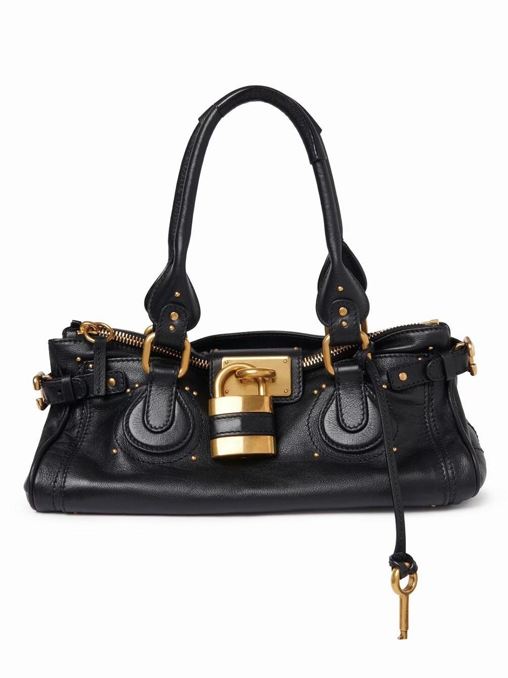2026 Neue Herbst/Winter Vintage Vielseitige Schlosskopf-Tasche mit Nieten-Kissen-Tasche schwarz