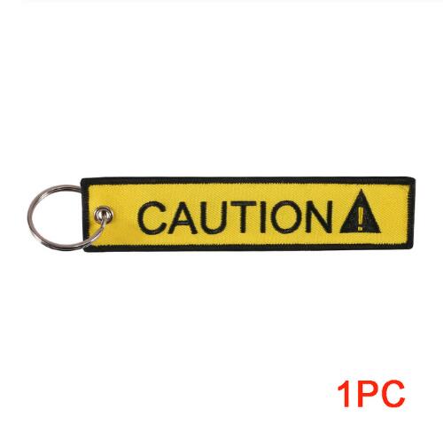 REMOVE BEFORE FLIGHT Neuheits-Schlüsselanhänger Launch-Schlüsselanhänger Bijoux-Schlüsselanhänger für Motorräder und Autos Schlüsselanhänger Neue bestickte Schlüsselanhänger Yellow CAUTION