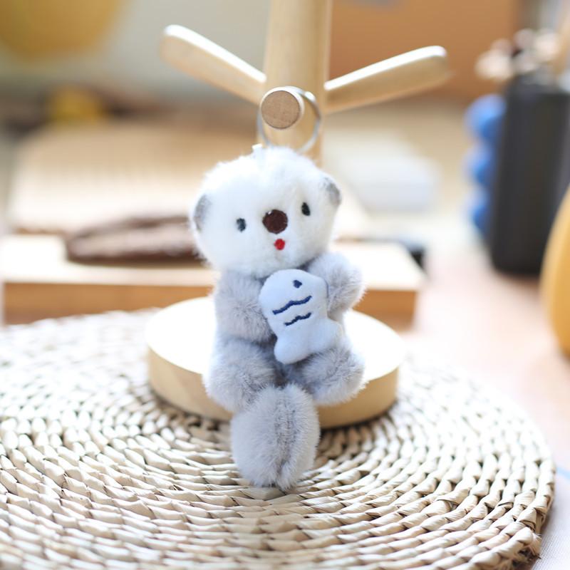 Süßer Seeotter hält Fisch Plüsch Anhänger Puppe Schlüsselanhänger Rucksack Schlüsselanhänger Anhänger Schlüsselanhänger Tasche Anhänger Schmuck Zubehör beige