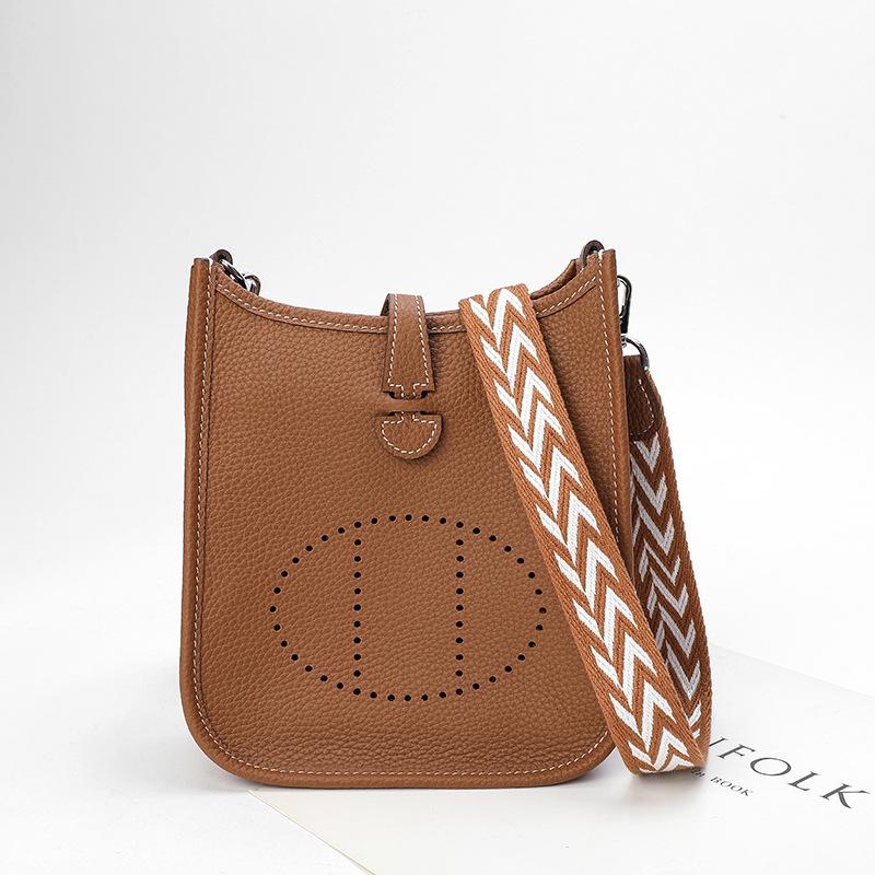 Fabrikgroßhandel erste Schicht Rindsleder Eimer Tasche Damen Tasche Litschi Muster Hohl Einzel Schulter Crossbody Tasche Hohl Design 28x9x30cm goldbraune
