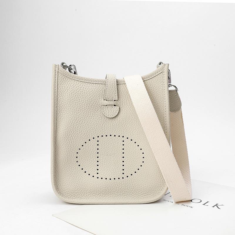Fabrikgroßhandel erste Schicht Rindsleder Eimer Tasche Damen Tasche Litschi Muster Hohl Einzel Schulter Crossbody Tasche Hohl Design 17x6x18cm grauweiß