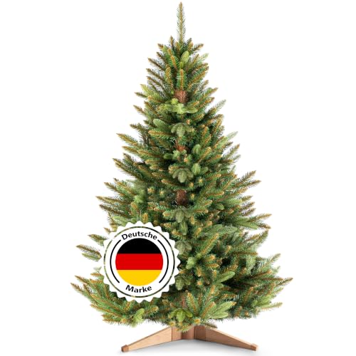 RESTILO Premium Künstlicher Weihnachtsbaum 150 cm - Naturgetreu, dichte Zweige Ø 95 cm | Nordmanntanne mit braunem Stamm & Holzständer | 10 Jahre Garantie | Tannenbaum künstlich I Made in EU | Maya